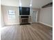 Cozy room with wood-look floors, a black brick fireplace, and natural light at 5804 Viking Rd, Orlando, FL 32808