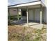 Covered patio with concrete flooring, gray supports, and neutral-colored walls with access doors at 5804 Viking Rd, Orlando, FL 32808