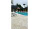 Community pool with lounge chairs and a covered outdoor area at 6013 Westgate Dr # 2421, Orlando, FL 32835