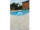 Community pool with lounge chairs and well maintained tile deck at 6013 Westgate Dr # 2421, Orlando, FL 32835