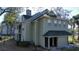 Inviting exterior view of a townhouse with a chimney and two front doors under a green roof at 6028 Westgate Dr # 104, Orlando, FL 32835