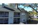 An exterior view of a two-story townhouse featuring a balcony and screened in patio at 6028 Westgate Dr # 104, Orlando, FL 32835