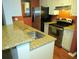 Close up of a modern kitchen with stainless steel appliances and granite countertops at 6028 Westgate Dr # 104, Orlando, FL 32835