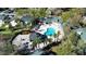 Aerial view of a community pool with a gazebo, mature trees and meticulous landscaping at 6028 Westgate Dr # 104, Orlando, FL 32835