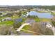 Expansive aerial view of a beautiful home with mature landscaping and a serene pond in a lovely neighborhood at 6301 Oak Shore Dr, St Cloud, FL 34771