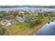 Aerial shot showcases a beautiful home and well-manicured lawn near a lake at 6301 Oak Shore Dr, St Cloud, FL 34771