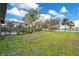 Expansive backyard with lush lawn, mature trees, and a playground near the water at 6301 Oak Shore Dr, St Cloud, FL 34771