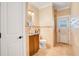 Well-lit bathroom featuring neutral tile and a door leading to the lanai at 6301 Oak Shore Dr, St Cloud, FL 34771