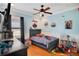 bedroom featuring hardwood floors, a ceiling fan, and decorative baseball decor at 6301 Oak Shore Dr, St Cloud, FL 34771