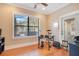 Bright bonus room featuring hardwood floors, a large window, and an electric drum kit at 6301 Oak Shore Dr, St Cloud, FL 34771