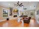 Spacious living room featuring hardwood floors, a cozy fireplace, and built-in shelving at 6301 Oak Shore Dr, St Cloud, FL 34771