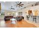 Open-concept living room showcasing hardwood floors and views of the kitchen area at 6301 Oak Shore Dr, St Cloud, FL 34771