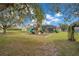 Backyard playground and screened pool area under the trees at 6301 Oak Shore Dr, St Cloud, FL 34771