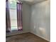 A bright bedroom features carpet flooring and a large window with vertical blinds at 6356 Bennett Ct, St Cloud, FL 34771