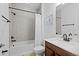 Modern bathroom featuring a shower-tub combination, dark fixtures, and a white countertop at 6699 Alder Rd, Harmony, FL 34773