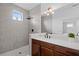 Modern bathroom featuring a walk-in shower, stylish vanity, and large mirror with accent lighting at 6699 Alder Rd, Harmony, FL 34773