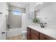 Modern bathroom with a tiled shower, white vanity, and bronze fixtures at 6699 Alder Rd, Harmony, FL 34773