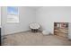 Minimalist bedroom with window, seating, and a bookshelf at 6699 Alder Rd, Harmony, FL 34773