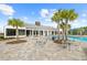 Inviting community pool area with elegant clubhouse and ample seating at 6699 Alder Rd, Harmony, FL 34773