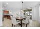 Open concept dining room with a wood table, cushioned chairs, and sliding glass doors to the patio at 6699 Alder Rd, Harmony, FL 34773