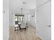 Dining room with modern light fixture, bright natural light, and wood-look tile floors at 6699 Alder Rd, Harmony, FL 34773