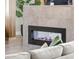 Contemporary fireplace with stone surround and modern design, complemented by stylish decor at 6699 Alder Rd, Harmony, FL 34773