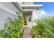 Charming entryway with a brick pathway, blooming flowers and a cheerful, decorative yellow door at 6699 Alder Rd, Harmony, FL 34773