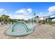 Community splash pad with water features and lounge chairs at 6699 Alder Rd, Harmony, FL 34773