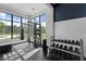 Bright workout area featuring weight rack, punching bag, and large windows with exterior views at 6699 Alder Rd, Harmony, FL 34773