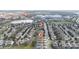 Scenic aerial of the neighborhood's houses and street layout with nearby lake and water park at 7735 Teascone Blvd, Kissimmee, FL 34747