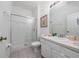 Well-lit bathroom with a glass-enclosed shower, white vanity, and tile flooring at 7735 Teascone Blvd, Kissimmee, FL 34747