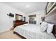 Bright bedroom featuring a TV, ensuite, and sliding glass doors leading to the pool area at 7735 Teascone Blvd, Kissimmee, FL 34747