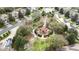 Aerial view of the community park featuring a playground, circular walking path, and ample green space at 7735 Teascone Blvd, Kissimmee, FL 34747