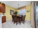 Dining area with wooden table and chairs, chandelier lighting, and views of the pool at 7735 Teascone Blvd, Kissimmee, FL 34747