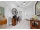 Bright foyer with white tile flooring, decorative wall art, and a small office nook at 7735 Teascone Blvd, Kissimmee, FL 34747