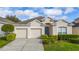 Charming single-story home features a two-car garage, neutral stucco facade, and well-manicured landscaping at 7735 Teascone Blvd, Kissimmee, FL 34747