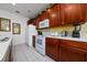 Well-lit kitchen with white appliances, wood cabinets, and ample counter space for cooking at 7735 Teascone Blvd, Kissimmee, FL 34747