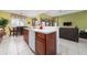 Open kitchen with breakfast bar overlooking dining area and a connected living space at 7735 Teascone Blvd, Kissimmee, FL 34747