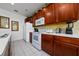 Bright kitchen with white appliances, dark wood cabinets, and ample counter space at 7735 Teascone Blvd, Kissimmee, FL 34747