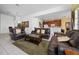 Living room view showcasing leather furniture and open layout to kitchen and dining areas at 7735 Teascone Blvd, Kissimmee, FL 34747