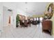 Open-concept living room with tiled floors seamlessly connects to dining area and kitchen at 7735 Teascone Blvd, Kissimmee, FL 34747