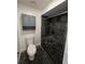 Bathroom with a toilet and tiled shower with seat, offering a functional and simple space at 832 Whalebone Bay Dr, Kissimmee, FL 34741