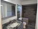 Bathroom featuring a modern vanity with marble countertop and large walk-in shower with gray tile at 832 Whalebone Bay Dr, Kissimmee, FL 34741