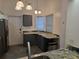 Modern kitchen area highlighting granite countertops, stainless sink, and new gray cabinets at 832 Whalebone Bay Dr, Kissimmee, FL 34741