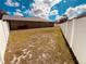 Wide view of the backyard enclosed by a white fence, providing a safe and private outdoor space at 881 Hudson Valley Dr, Kissimmee, FL 34759