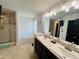 Bright bathroom with dual sinks, soaking tub, and glass-enclosed shower at 881 Hudson Valley Dr, Kissimmee, FL 34759