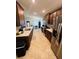 A modern kitchen featuring stainless steel appliances and seamless flow into the dining area at 881 Hudson Valley Dr, Kissimmee, FL 34759