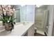 Bright bathroom featuring a well-lit vanity, a toilet, and a shower/tub with a white curtain at 8824 Grand Palms Cir # A, Kissimmee, FL 34747