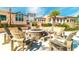 Outdoor community fire pit surrounded by comfortable Adirondack chairs and professionally landscaped grounds with modern buildings at 8962 Hilton Ridge Ave, Kissimmee, FL 34747