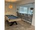 Entertainment area complete with a pool table and bar-style seating for relaxation and fun at 8962 Hilton Ridge Ave, Kissimmee, FL 34747